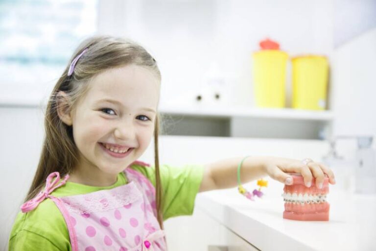 Girl holding model of teeth