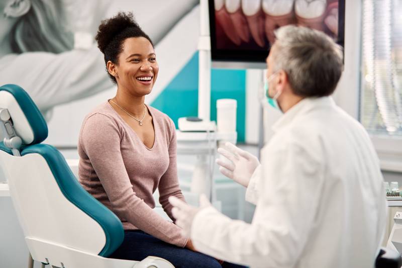 A patient speaking with her provider about modern dentistry.