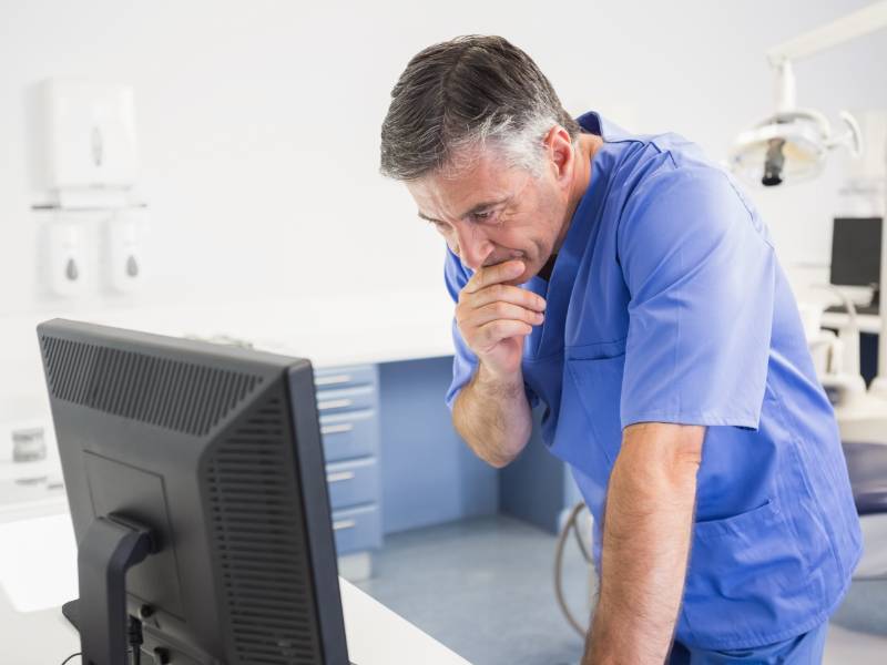 Dentist at computer